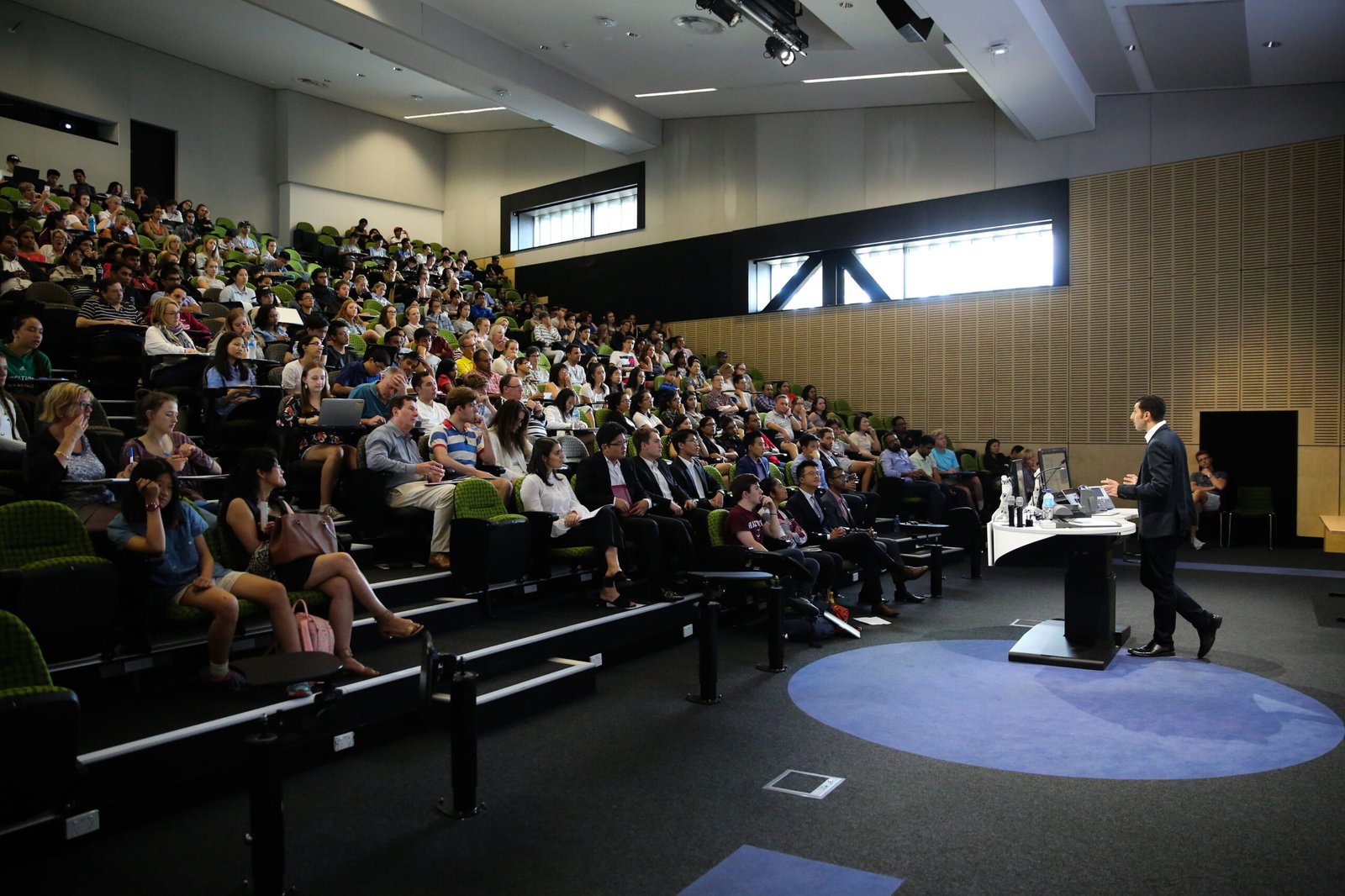 Mark Bekhit presenting to a full lecture theatre